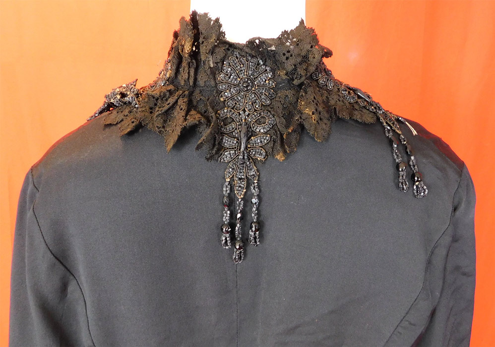 Victorian Black Silk Jet Beaded Fringe Tassel Trim Dolman Mantle Cloak Cape
It is in fair as-is condition, needing some restoration, with several small frays, splits scattered on the silk fabric, a small frayed hole on the shoulder, some discoloration fading on the black lace collar trim and some loose, missing beads (see close-ups). This is truly a wonderful piece of antique Victoriana wearable art! 