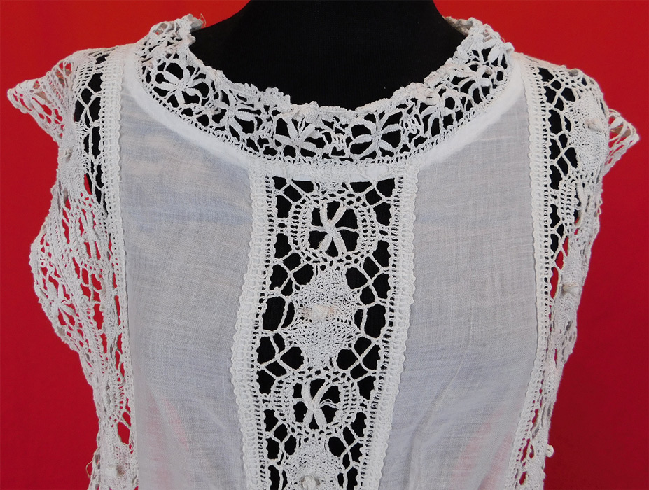 Edwardian White Cotton Batiste Cluny Torchon Bobbin Lace Tabard Tunic Top Dress
This antique Edwardian era white cotton batiste cluny torchon bobbin lace tabard tunic top dress dates from 1910. It is made of sheer white cotton batiste fabric with handmade cluny torchon bobbin lace trim with geometric patterns, spiderweb decorative designs. 