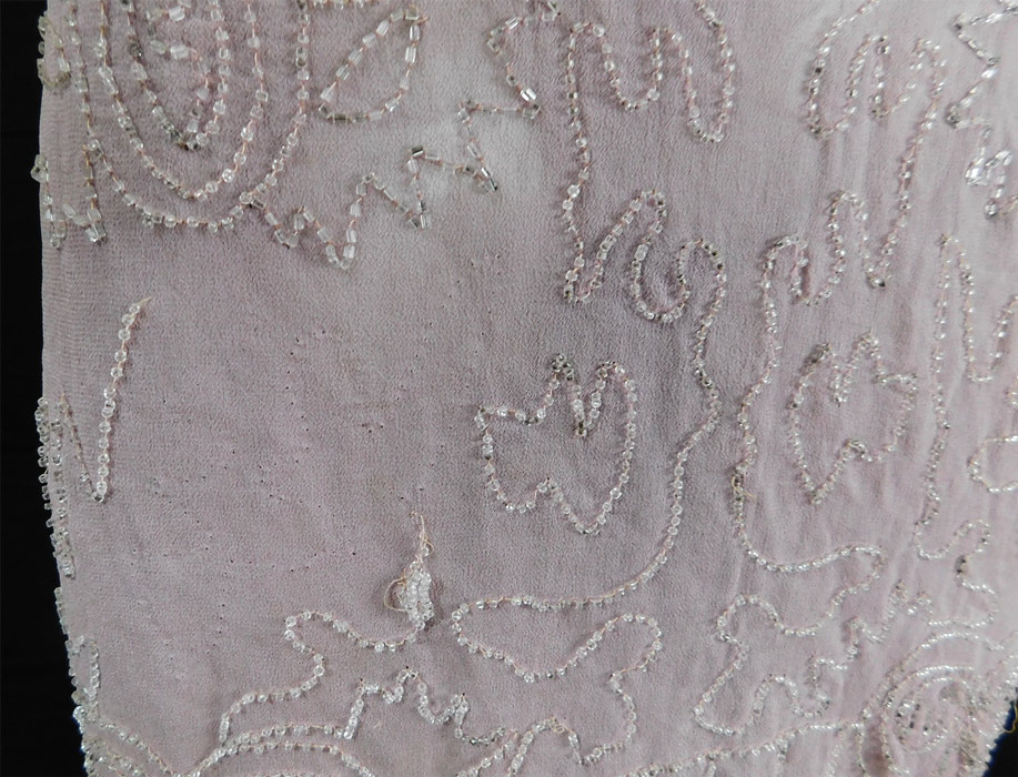 Vintage Art Deco Lilac Pink Sheer Silk Chiffon Crystal Beaded Flapper Dress
The dress measures 41 inches long, with a 34 inch bust, 34 inch waist and 38 inch hips.
