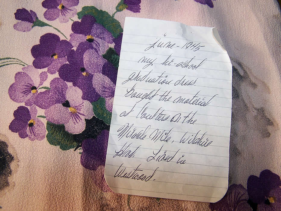 There is an attached note of provenance stating it was worn June 1945 for high school graduation and the material was purchased at Coulters Department Store on Wilshire Blvd. in Los Angeles.