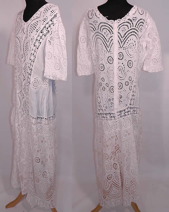 Edwardian White Cotton Batiste Eyelet Lace Large Size Graduation Tea Dress. This lovely lace loose fitting long floor length dress has a drop waist style, with rounded scoop necklines, 3/4 length sleeves and hidden hooks down the back for closure. It is sheer and unlined. The dress is a large size measuring 55 inches long, with 40 inch hips, a 34 inch waist, 40 inch bust, 17 inch back and 12 inch long sleeves.