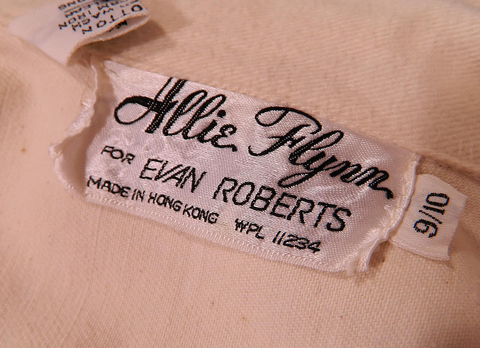 There is an "Allie Flynn for Evan Roberts" Made in Hong Kong designer label, size 9/10 tag. Vintage Allie Flynn for Evan Roberts Claude Monet Painted Pant Suit Jacket Bell Bottoms label close up.