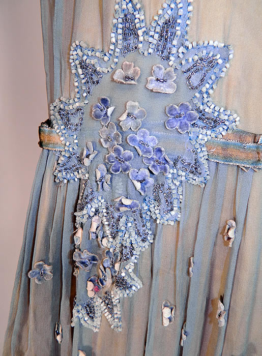 Vintage Blue & Yellow Silk Beaded Velvet Rosette Drop Waist Flapper Dress. This fabulous flapper dress has a drop waist, belted waist, sleeveless, with a scalloped hemline skirt and side snap closures. There is a yellow silk satin slip dress lining sewn inside, with gold metallic lam&eacute; lace trim edging. 