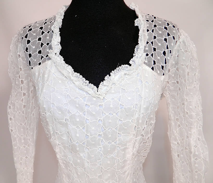 Vintage White Eyelet Flower Organdy Wedding Gown Dress. This beautiful bridal wedding gown dress is a long floor length, has a sweetheart neckline, ruffled trim edging, long fitted sleeves, a side zipper closure, fully lined and a full skirt with slight back train.
