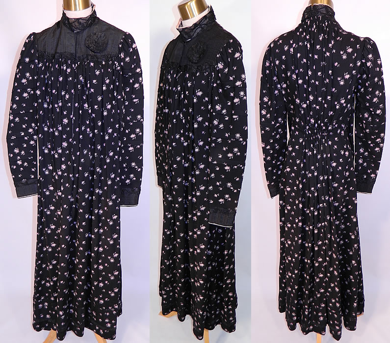 Victorian Black Wool Purple Lilac Floral Print Wrapper Morning Robe Dress Gown. It is made of a black fine wool fabric with a purple lilac flower print. There is a black silk pleated yoke, with soutache trim, collar, cuffs and rosette.