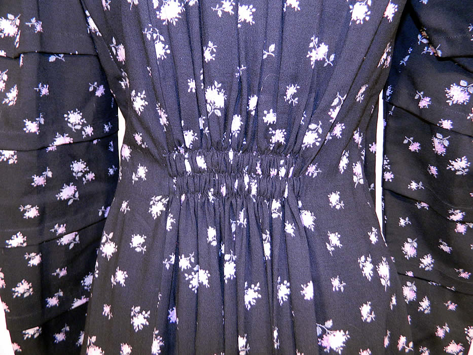 Victorian Black Wool Purple Lilac Floral Print Wrapper Morning Robe Dress Gown. The gown measures 52 inches long, with 46 inch hips, a 46 inch waist, 34 inch bust, 13 1/2 inch back and 25 inch long sleeves. 