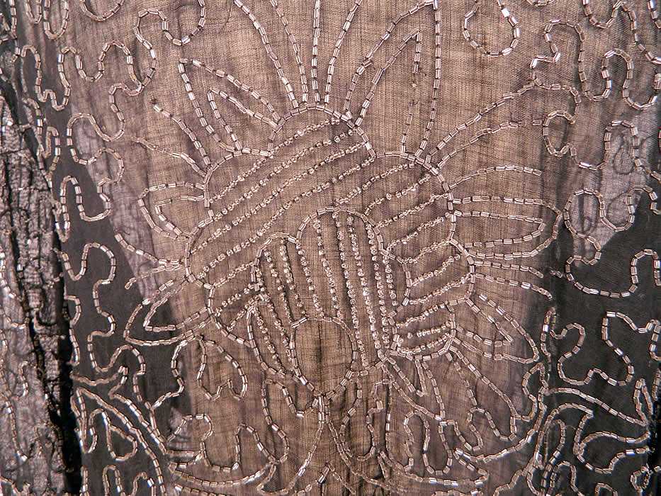 Vintage Art Deco Black Cotton Muslin Crystal Beaded Flapper Coat Jacket. This exquisite evening coat flapper jacket is mid length, loose fitting, with long full sleeves, an open front with no closure and is sheer, unlined. The jacket measures 25 inches long, with a 38 inch waist, 38 inch bust, 15 inch back and 22 inch long sleeves.