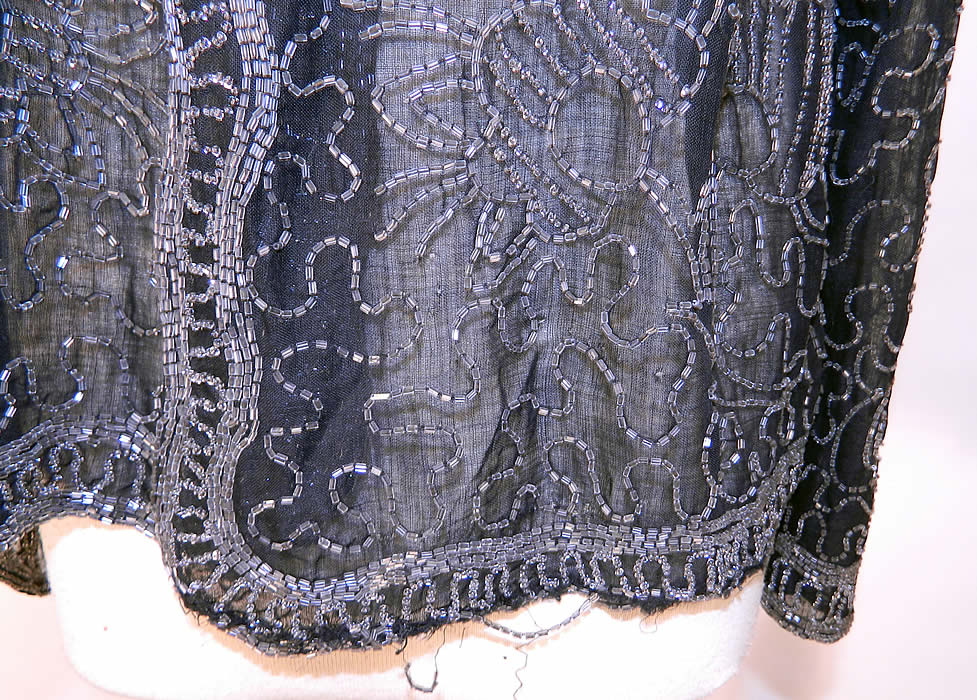 Vintage Art Deco Black Cotton Muslin Crystal Beaded Flapper Coat Jacket. It is in good condition, with only a few loose missing beads, a small fray on the bottom front hem and mended repair on the back neck.