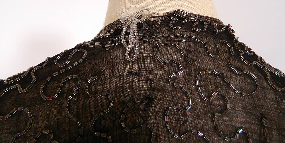 Vintage Art Deco Black Cotton Muslin Crystal Beaded Flapper Coat Jacket. It is in good condition, with only a few loose missing beads, a small fray on the bottom front hem and mended repair on the back neck.