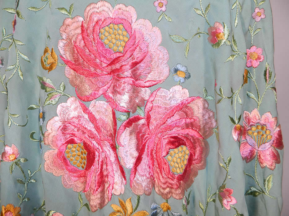 Antique Light Blue Silk Pink Floral Embroidered Fringe Boho Piano Shawl. There is a light turquoise blue hand knotted silk fringe which measures 16 inches long surrounding the entire shawl.