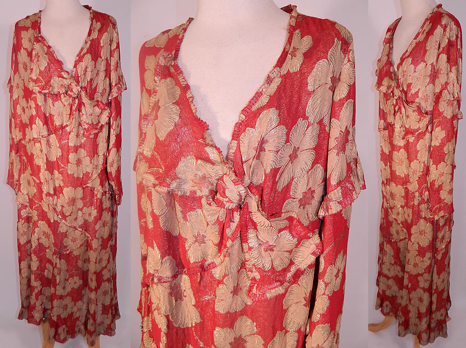Vintage Art Deco Red Silk Gold Lamé Floral Poppy Drop Waist Dress Large Size. It is made of a reddish orange color silk lamé fabric, with gold metallic threads woven through it creating a floral poppy pattern. This fabulous flapper dress is loose fitting, with a drop waist, long sleeves with button cuffs, an asymmetrical knotted trim V neckline with pleated ruffle trim edging and a long mid length skirt.