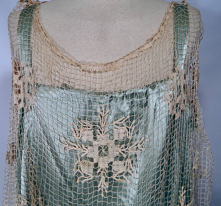 Vintage Blue Silk Cream Crochet Lace Wax Flower Ribbon Drop Waist Wedding Dress. This beautiful bridal wedding gown dress is loose fitting, has a drop waist, long floor length skirt, sleeveless with open sides and a drawstring neckline on the slip lining. The dress is a large size measuring 55 inches long, with 46 inch hips, a 44 inch waist and 50 inch bust. The slip lining measures 54 inches long, with 46 inch hips, a 40 inch waist and 38 inch bust which is adjustable.