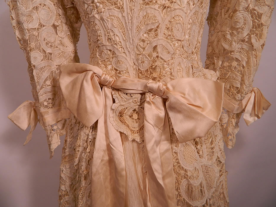 Edwardian Antique Battenburg Crochet Tape Lace Wedding Gown Dress. It is fully lined in silk. The top measures 19 inches long, with a 30 inch waist, 36 inch bust, 14 inch back and 18 inch long sleeves. There is a matching lace long floor length full skirt with slight train back, sheer silk chiffon pleated back panel insert, fully lined in silk with petticoat skirt underneath and hook closures on the back.