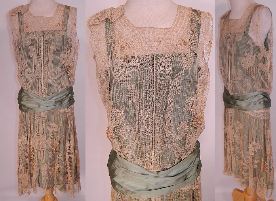 Vintage Teal Silk Ecru Filet Lace Wooden Beaded Drop Waist Belted Dress. This vintage teal silk ecru filet lace wooden beaded drop waist belted dress dates from the 1920s. It is made of a bluish green light teal color silk fabric slip lining underneath, with a sheer off white ecru cream color crochet net filet lace floral pattern overdress and wooden bead accents.