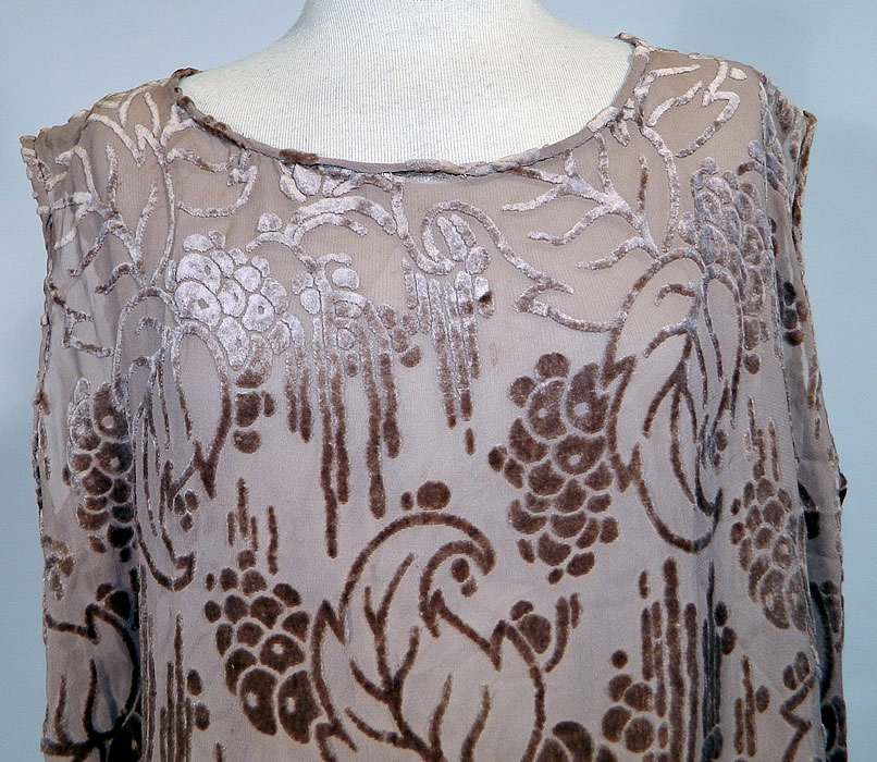 Art Deco Vintage Ecru Silk Burnout Voided Velvet Drop Waist Flapper Dress. This fabulous flapper style loose fitting drop waist dress is sleeveless, with a rounded scoop neckline, side hip gathers with gray fur trim edging and a side skirt drape panel. The dress measures 42 inches long, with 40 inch hips, a 40 inch waist, 40 inch bust and 5 inch skirt hem.