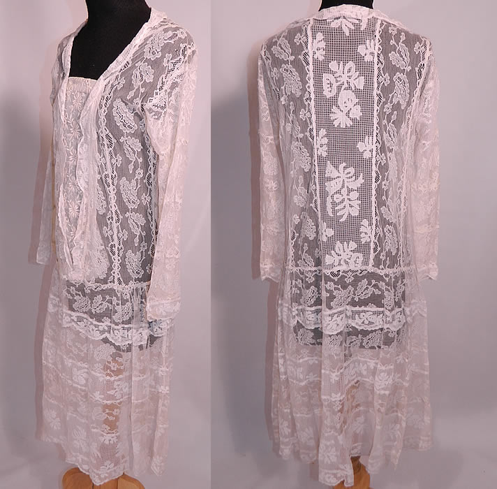 Vintage Normandy Lace White Embroidered Batiste Applique Drop Waist Dress. This lovely lace drop waist dress is loose fitting, with a ruffled trim front neckline, long sleeves, snap closures along the front bib insert panel and is sheer, unlined. The dress measures 42 inches long, with 36 inch hips, a 32 inch waist, 34 inch bust, 16 inch back and 18 inch long sleeves. 