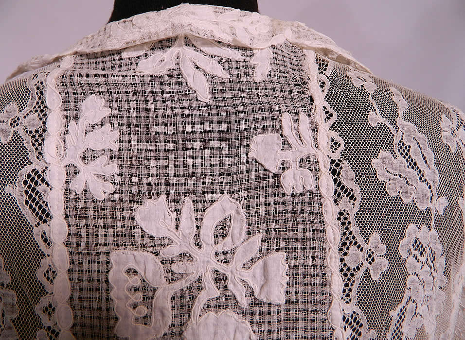 Vintage Normandy Lace White Embroidered Batiste Applique Drop Waist Dress. The dress measures 42 inches long, with 36 inch hips, a 32 inch waist, 34 inch bust, 16 inch back and 18 inch long sleeves. It is in good condition, with only a small frayed pull on the back mesh net fabric (see close-up). This is truly a rare and exceptional piece of wearable lace art! 
