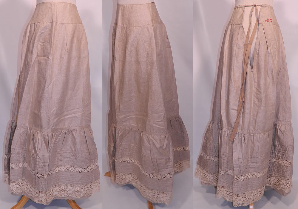 Victorian Linen & Lace Embroidered Initials Drawstring Petticoat Skirt. This antique Victorian era linen and lace embroidered initials drawstring petticoat skirt dates from 1890. It is made of a heavy fine quality ecru color flax linen fabric, with pleating and cream color lace trim along the bottom and a layered ruffle hemline.