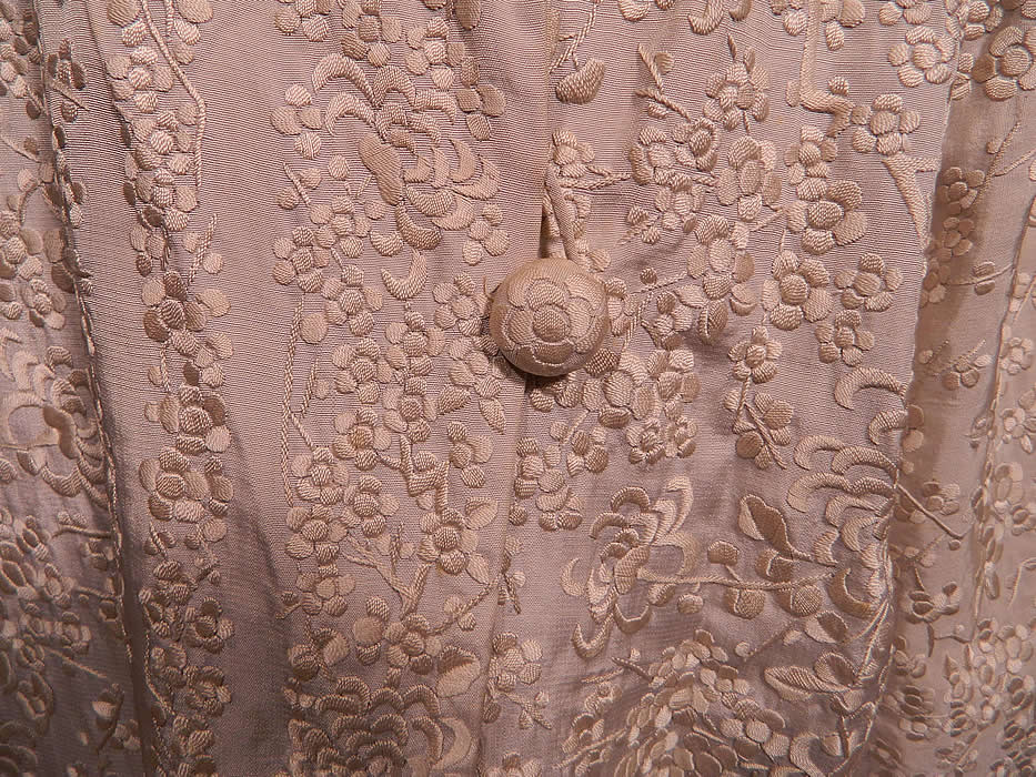 Vintage Chinese White Silk Floral Embroidered Piano Shawl Long Coat Jacket. This exquisitely embroidered quality made jacket has a long loose fitting boxy style, with long full sleeves, an embroidered wide lapel collar, single silk button front closure at the waist and is fully lined in silk inside. It was created from an antique finely embroidered Canton Chinese piano shawl fabric.