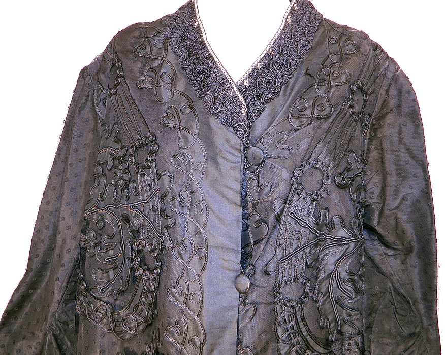Edwardian Titanic Black Silk Soutache Applique Lace Long Coat Jacket. It is made of a layered black silk taffeta fabric covered with a sheer black polka dot net fabric, soutache work braided trim and black silk appliques cutout in a spiral scrolling floral leaf pattern design.