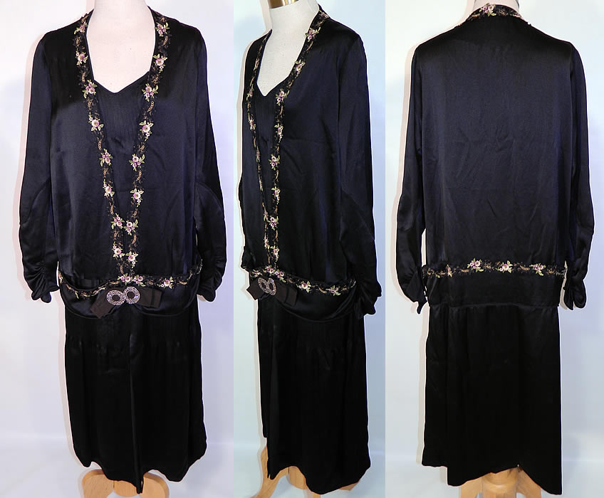 Vintage Flapper Black Silk Gold Violet Floral Embroidered Trim Drop Waist Dress. This vintage Art Deco flapper black silk gold violet floral embroidered trim drop waist dress dates from the 1920s. It is made of a black silk fabric, with pleating on the front neckline, waist and gold metallic, purple violet floral embroidered applique trim edging.