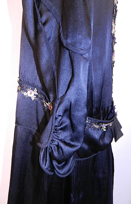Vintage Flapper Black Silk Gold Violet Floral Embroidered Trim Drop Waist Dress. The dress measures 45 inches long, with 40 inch hips, a 38 inch waist, 40 inch bust, 14 inch back and 24 inch long sleeves. It is in good condition. This is truly a wonderful piece of wearable Art Deco textile art! 