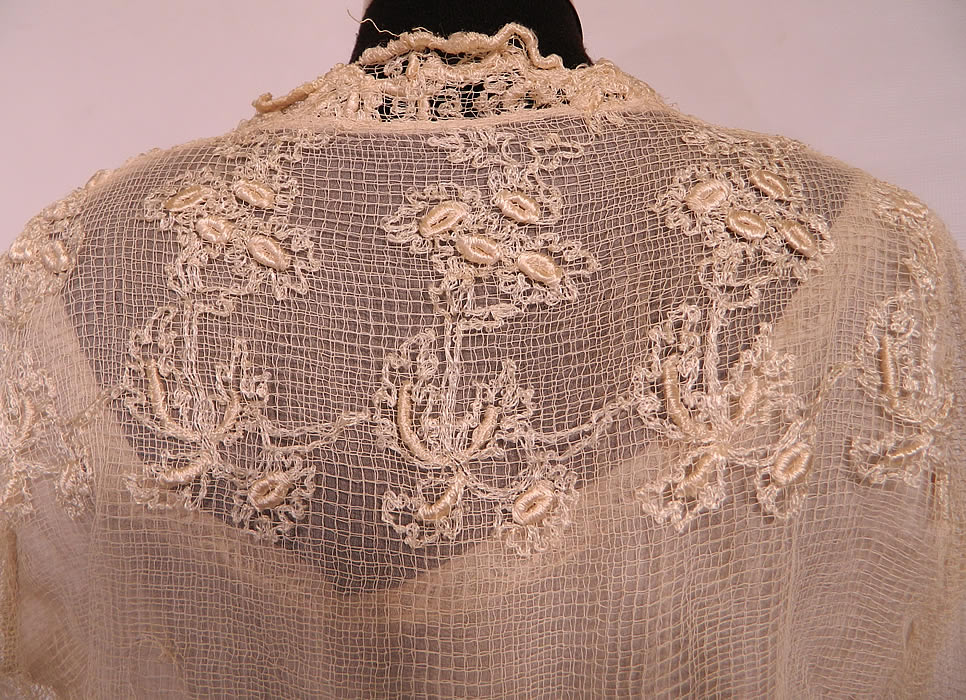 Edwardian Titanic Embroidered Ecru  Net Crochet Filet Lace Dress. This lovely lace dress is a long floor length, with a layered cropped jacket style overlay top, with a peplum skirted waist, long full sleeves and a tiered ruffle skirt. It is fully lined in a cream color silk slip dress, with snap hook closures along the front side. 