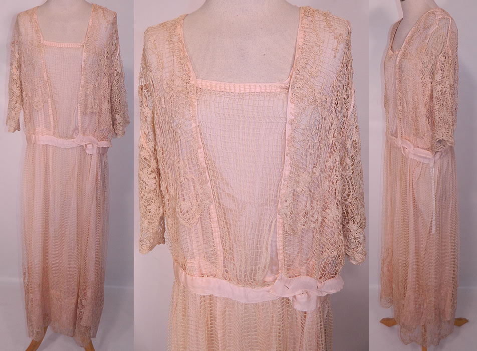 Edwardian Titanic Pink Silk Ecru Net Crochet Filet Lace Dress. This exquisite vintage Edwardian Titanic era pink silk ecru net crochet filet lace dress dates from 1915. It is made of a pink silk underdress, covered with an off white ecru cream color sheer mesh net fabric with a floral leaf pattern filet lace overdress. 