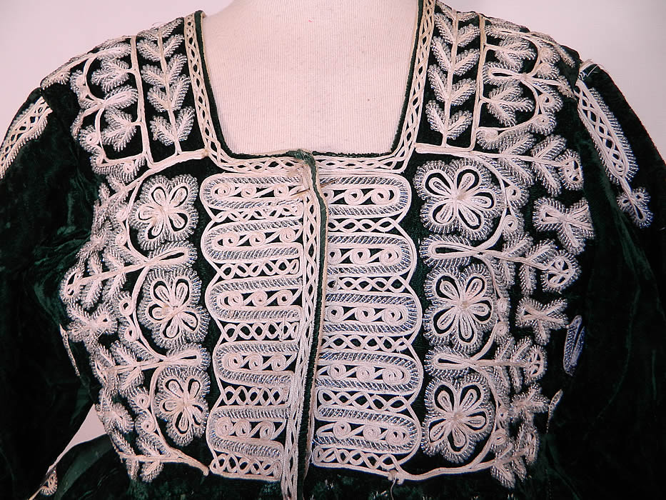 Antique Spanish Conquistador Bolivian Milkmaids Folk Costume Velvet Beaded JacketAntique Spanish Conquistador Bolivian Milkmaids Folk Costume Velvet Beaded Jacket. It is hand stitched, made of a dark green velvet fabric, with crystal beading and white braided trim. There are decorative floral, leaf, heart, dove of peace bird beaded designs, a breastplate style front opening and white silk fringe trim along the bottom. 