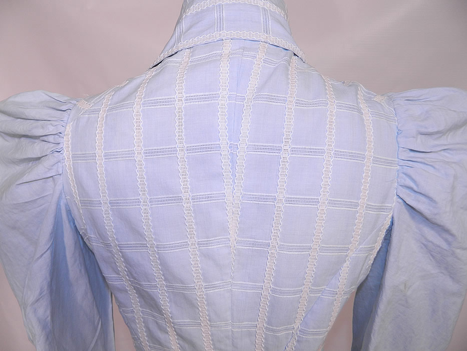 Victorian Blue & White Windowpane Cotton Peplum Blouse Bustle Skirt Dress. The bodice measures 27 inches long, with a 22 inch waist, 32 inch bust, 11 inch back and 26 inch long sleeves. There is a matching fabric long floor length full skirt, with a slight bustle back drape and layered ruffled hemline. The skirt measures 45 inches long, with a 22 inch waist.