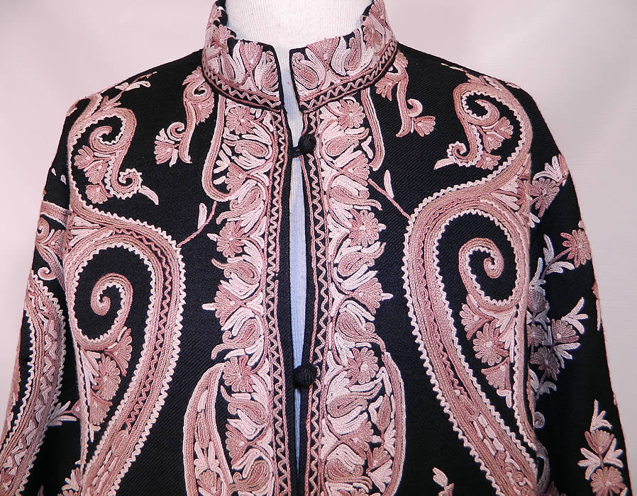 Vintage Paisley Chain Stitch Crewel Work Embroidery Black & Ecru Wool Coat. The elaborate design work completely covers the entire coat. This beautiful boho jacket has a loose fitting boxy style, with a mandarin collar, long full sleeves, wool button closures down the front and is fully lined. 