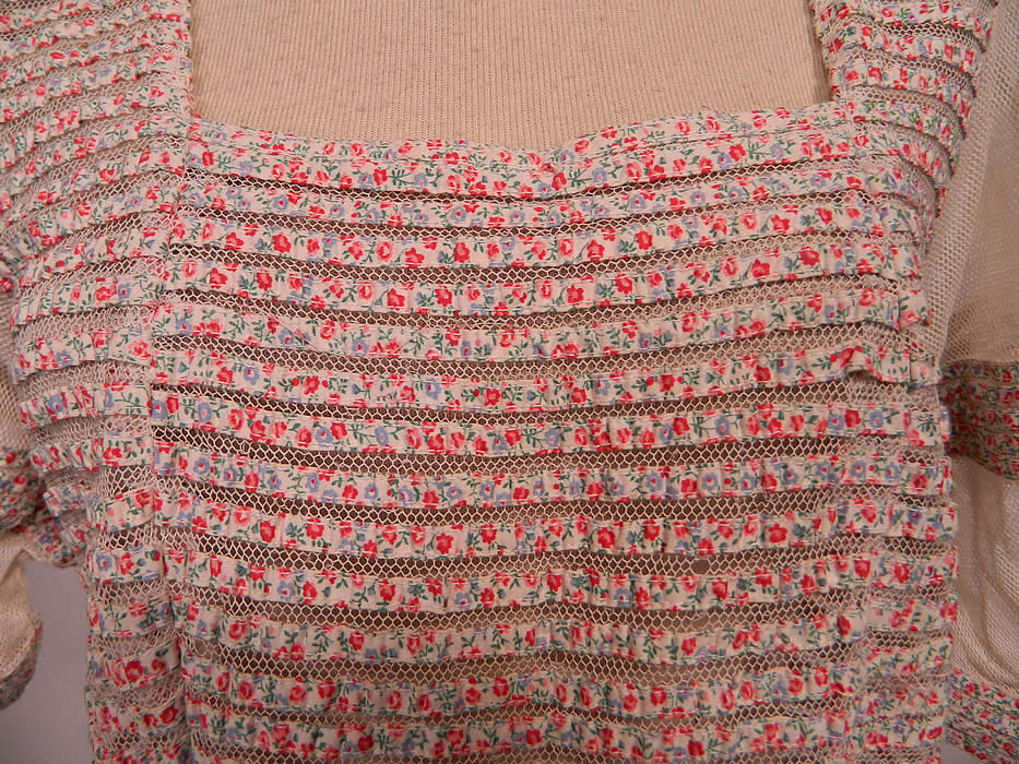 Vintage Pleated White Net Ribbon Floral Print Striped Trim Dress. This gorgeous gown has a long full floor length skirt, short sleeves, a squared front neckline, long fitted drop waist, lined in white netting and has a side zipper closure.