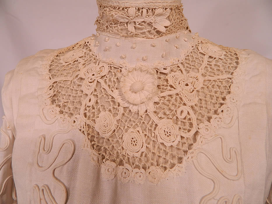 Edwardian White Linen Irish Crochet Lace Soutache French Knot Button Dress. This lovely lace long floor length dress has pleating along the shoulders, a pouter pigeon front top, lace yoke high collar neckline, long sleeves, decorative fabric covered button trim down the back and hook closures on the back. 