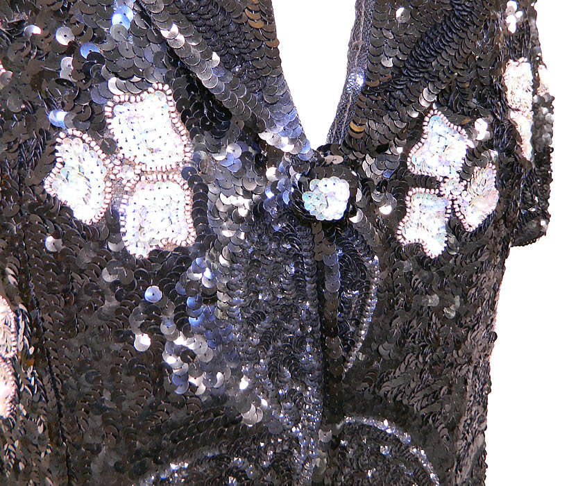 Vintage Black Net   Sequin Beaded Iridescent Gold Flowers Evening Jacket. This beautiful beaded evening jacket has slight shoulder padding, short sleeves, a wide lapel collar, sequin beaded button snap closure, peplum skirted bottom and is unlined.