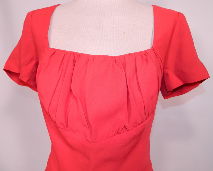 Vintage Don Loper Originals Red Silk Crepe Cocktail Sheath Dress. This radiant red holiday cocktail party dress has a form fitting sheath style, with a pleated bustline top, squared front neckline, plunging V back, short sleeves and back zipper closure.