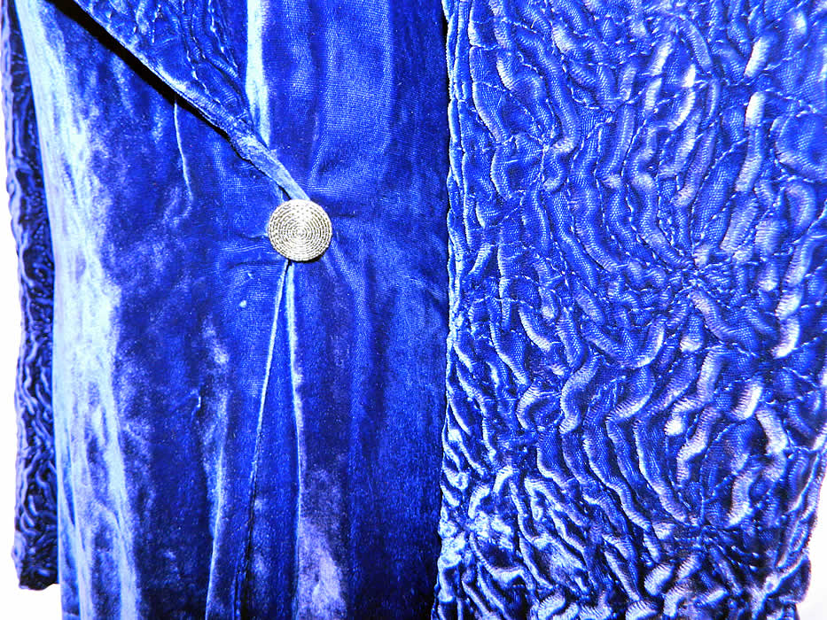 Vintage Royal Blue Silk Velvet Quilted Long Floor Length Evening Opera Coat. This opulent opera evening coat is a long floor length, with a wide lapel collar, long full tapered sleeves, a silver button side waist closure, with inside tie and a white silk satin lining.