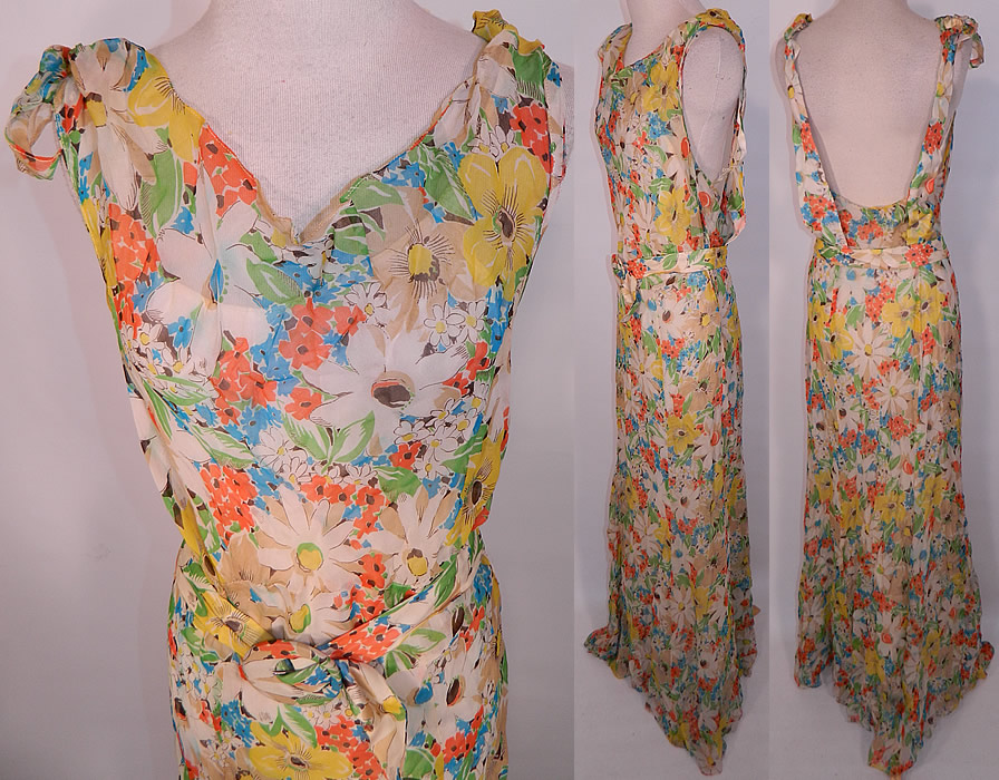 Vintage Daisy Flower Print Silk Chiffon Belted Bias Cut Dress Slip Cloak Cape. The dress measures 60 inches long, with 36 inch hips, a 28 inch waist and 34 inch bust. It is in good condition. Included is a matching fabric cloak cape, with smocking along the shoulders and a neck tie closure.