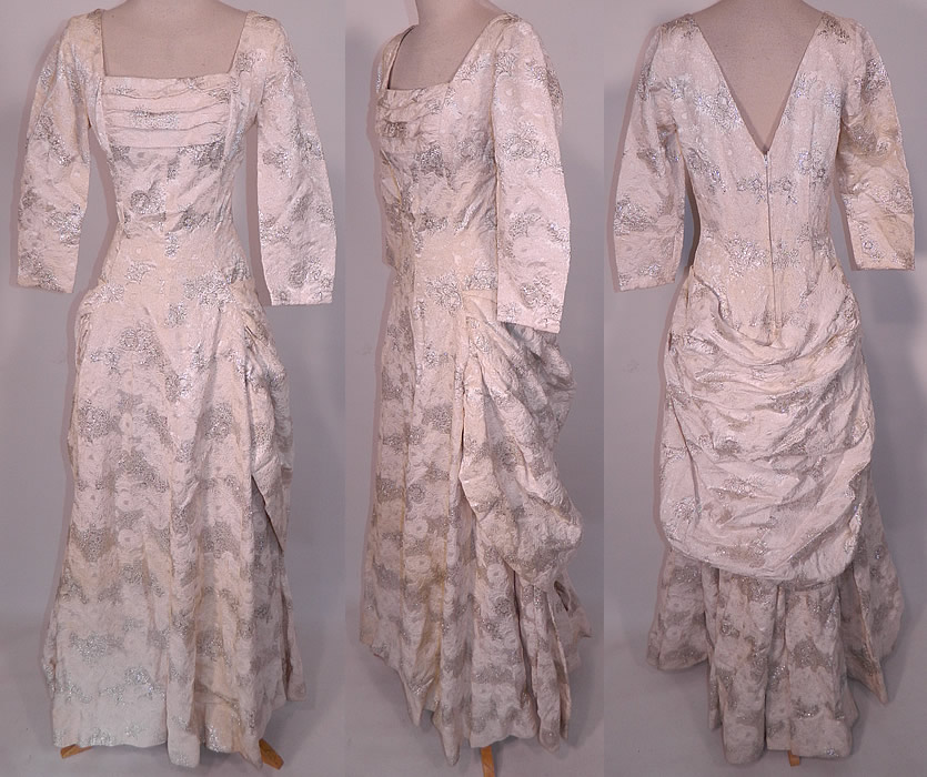Vintage Vogue Couturier Design Silver Lame Brocade Sheath Dress Evening Gown Lam&eacute;. This vintage Vogue Couturier Design silver lam&eacute; brocade sheath dress evening gown dates from the 1950s. It is made of a luxurious white satin fabric with silver metallic lam&eacute; and white embroidery work done in a floral leaf brocade design. 