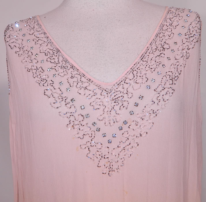 Vintage Art Deco Pink Silk Rhinestone Silver Beaded  Flapper Dress. This fabulous flapper dress has a loose fitting drop waist shift style, sleeveless, a V front neckline, scalloped hemline skirt and is unlined. 