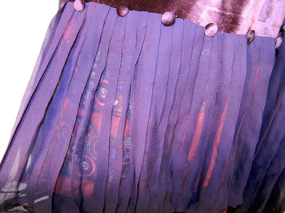 Vintage Aubergine Silk Velvet Embroidered Applique Trim Drop Waist Dress. There are a pair of matching colorful gold metallic Art Deco embroidered applique trim hidden underneath the pleated sheer silk front panel and velvet button trim accents.