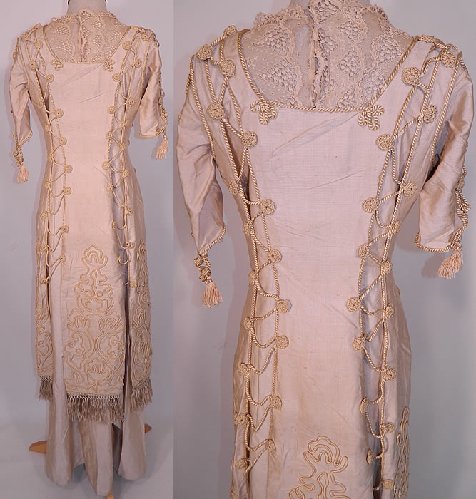 Edwardian Ecru Raw Silk Soutache Rope Lacing Corset Dress. This lovely lace long floor length dress has a layered pinafore apron style, with side hook lacing closures, short sleeves with corset lacing details, fringed trim bottom, velvet belted front waist and hook closures on the inside back. 
