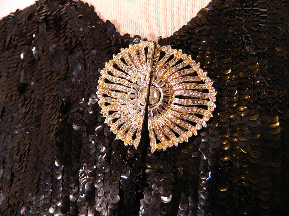 Vintage Black Sequin Beaded Rhinestone Clasp Cropped Bolero Evening Jacket. This beautiful beaded bolero evening jacket has a short cropped  style, with short sleeves, a clasp closure on the front neck and is fully lined in a black silk fabric. The jacket measures 15 inches long, with a 40 inch waist and 40 inch bust. 