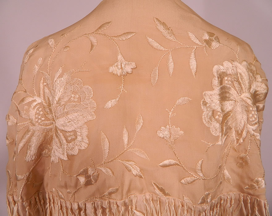Vintage Cream Silk Floral Embroidered Fringed Piano Shawl Coat Cloak Cape. This lovely long mid length loose fitting cloak cape style coat has a tiered layered design with fringe hanging around the mid section, with an open front, with no closure, sleeveless with large shawl collar covering it and is fully lined in pink silk.