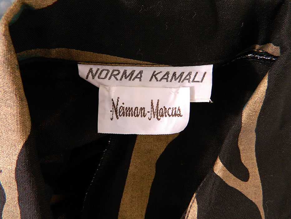 Vintage Norma Kamali Gold Lamé Tiger Stripe Print Wrap Dress Neiman Marcus. There is a "Norma Kamali" designer label, "Neiman Marcus" department store label and size Medium tag sewn inside. The dress measures 35 inches long, with 38 inch hips, am adjustable 38 inch waist, 36 inch bust, 15 inch back and 23 inch long sleeves. It is in good condition. This is a wonderful piece of quality made designer wearable art!