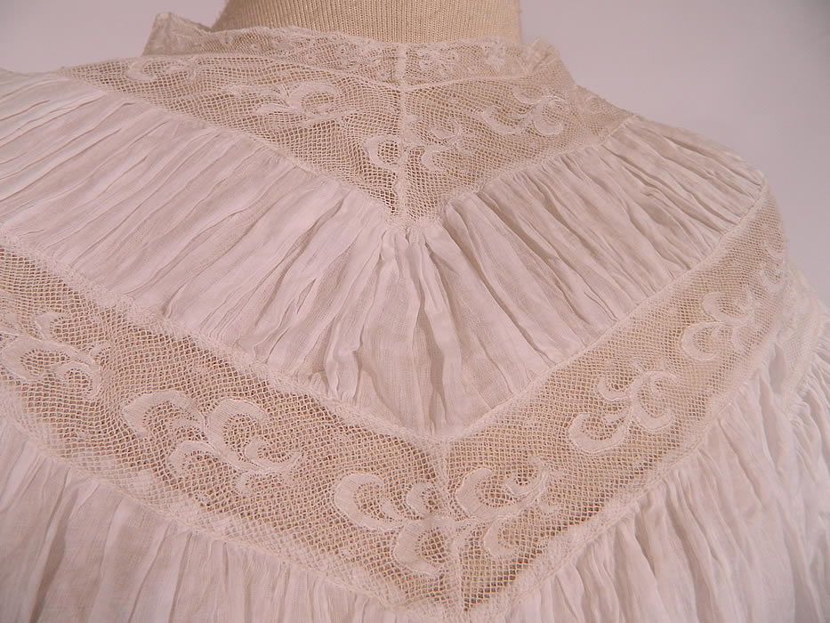Edwardian White Batiste Lawn Lace Wedding Dress Blouse Skirt Train. This beautiful bridal two piece wedding dress includes a blouse with a pouter pigeon front, long full sleeves with flared wide cuffs, a fitted waist, hook closures down the back and is unlined. The blouse measures 17 inches long, with a 22 inch waist, 34 inch bust, 13 inch back and 26 inch long sleeves.