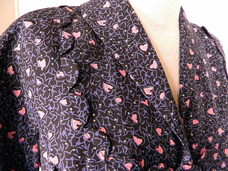 Vintage Mollie Parnis Heart Novelty Print Silk Circle Skirt Peplum Suit Jacket Dress. It is made of a navy blue silk rayon fabric background, with a pink abstract Valentine hearts novelty print design.