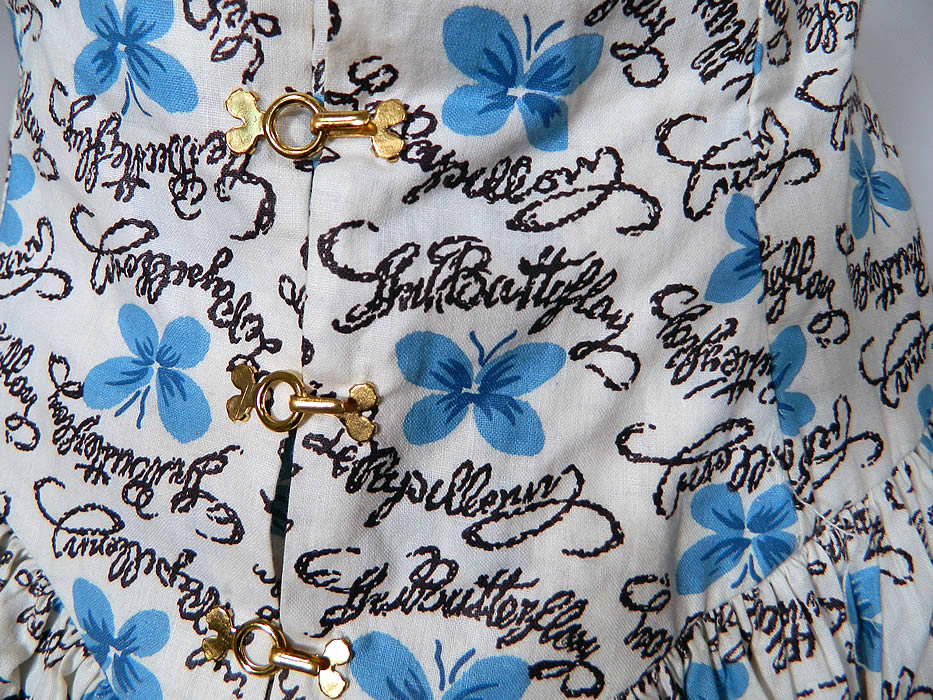 Vintage Blue Butterfly Papillon Print Cotton Circle Skirt Summer Sun Dress. This sensational summer sun dress has blue trim spaghetti straps, pleated gathering on the front neckline, a fitted drop waist with gold clasp hooks, a full circle skirt and back zipper closure.
