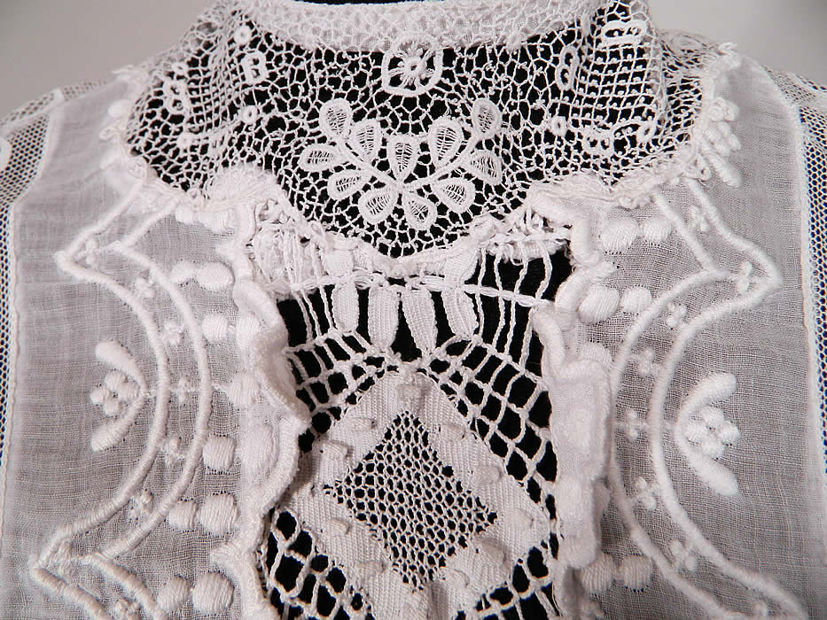 Edwardian Embroidered White Cotton Batiste Lace Graduation Wedding Dress. This lovely lace lawn dress is a long tea length, with short sleeves, a fitted waist, button back closures and  is sheer, unlined.
