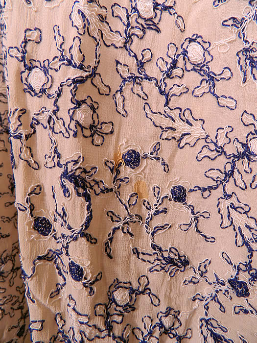 Vintage White Cotton Lace Blue Embroidered Stitching Belted Swing Day Dress. The dress measures 38 inches long, with 34 inch hips, a 30 inch waist, 36 inch bust and 14 inch back. It is in good condition, with only a small faint age spot stain on the skirt and a small frayed hole under the arm and on the sleeve (see close-ups).