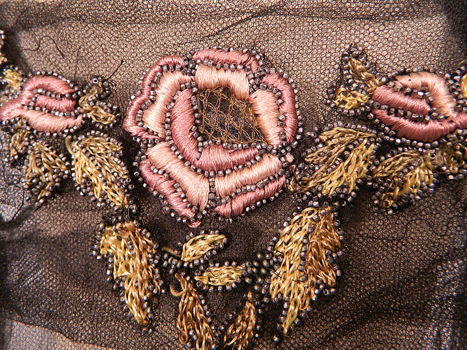 Vintage Black Net Beaded Embroidered Applique Made in France Flapper Dress. There are large colorful silk embroidered rose flower leaf applique trim outlined in beading, with gold metallic thread accents sewn along the top and bottom.